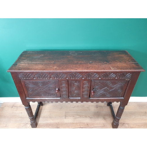 682 - A 17th Century and later oak Cupboard or Hutch fitted pair of carved doors mounted upon turned front... 