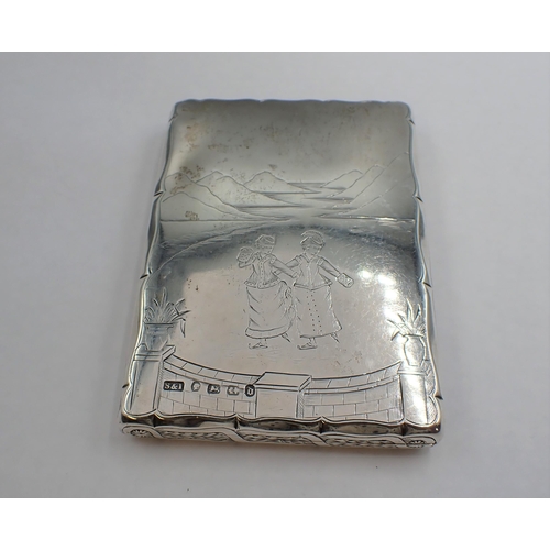 73 - A Victorian silver Card Case with silk interior engraved ladies skating on a lake and ferns to rever... 