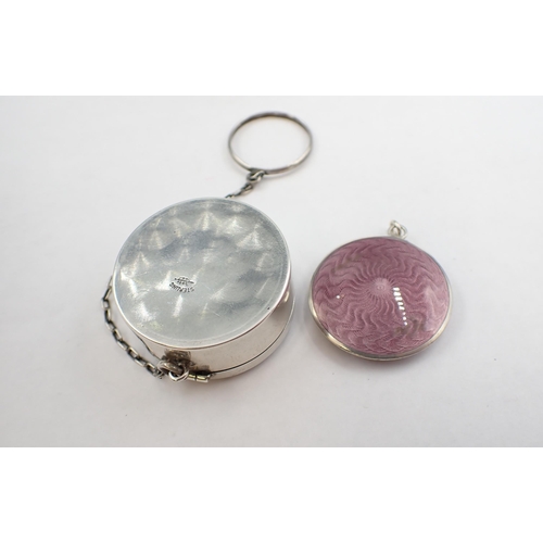 82 - Two small mauve enamel on silver Compacts