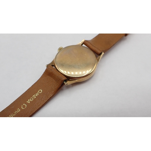 97 - A gentleman's 1956 9ct gold cased Omega manual wind Wristwatch the champagne dial with arabic numera... 