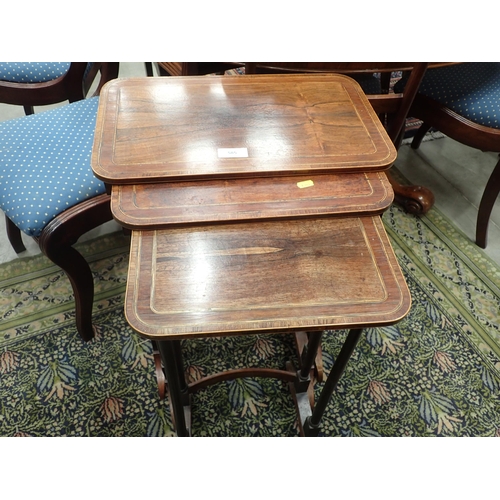 585 - A 19th Century Nest of three rosewood and satinwood strung Occasional Tables with rounded corners mo... 