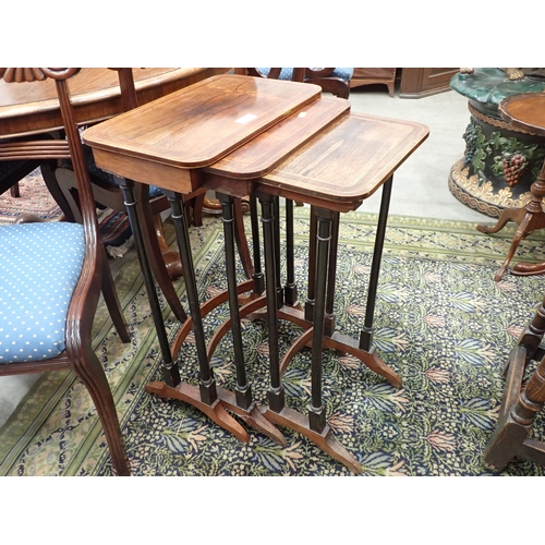 585 - A 19th Century Nest of three rosewood and satinwood strung Occasional Tables with rounded corners mo... 