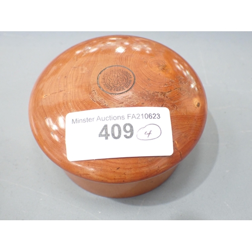 409 - A turned boxwood Box with threaded domed cover, cork lined, marked S. Maw & Sons of London, 3½in dia... 