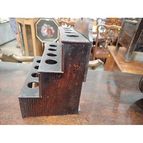 477 - An 18th Century Welsh oak Spoon Rack with raised shaped top, three tiers, cupids bow cut out design ... 