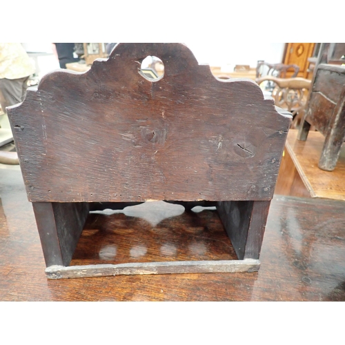 477 - An 18th Century Welsh oak Spoon Rack with raised shaped top, three tiers, cupids bow cut out design ... 