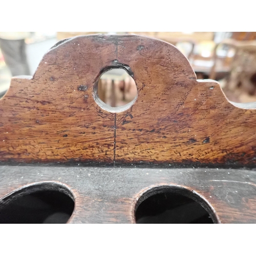 477 - An 18th Century Welsh oak Spoon Rack with raised shaped top, three tiers, cupids bow cut out design ... 