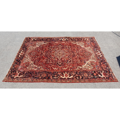 1 - A large Persian Carpet, the wide border with stylised motifs, the center ground with floral designs ... 