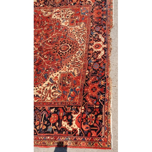 1 - A large Persian Carpet, the wide border with stylised motifs, the center ground with floral designs ... 