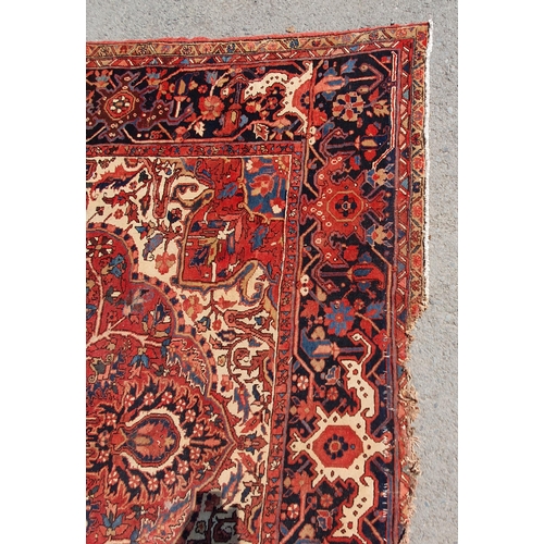 1 - A large Persian Carpet, the wide border with stylised motifs, the center ground with floral designs ... 