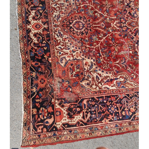 1 - A large Persian Carpet, the wide border with stylised motifs, the center ground with floral designs ... 