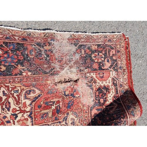 1 - A large Persian Carpet, the wide border with stylised motifs, the center ground with floral designs ... 