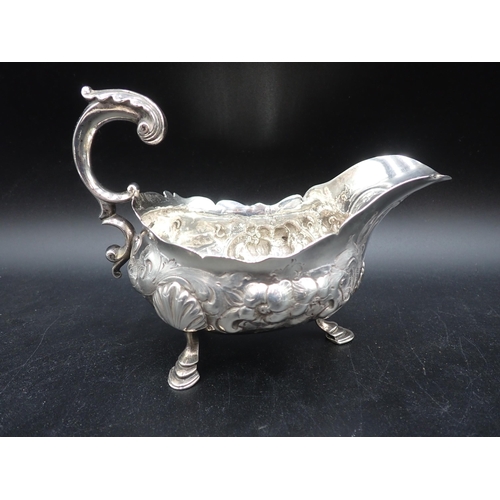 113 - A pair of George III large silver Sauce Boats with later floral embossing, leafage scroll handles on... 