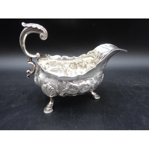 113 - A pair of George III large silver Sauce Boats with later floral embossing, leafage scroll handles on... 