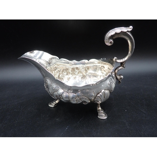 113 - A pair of George III large silver Sauce Boats with later floral embossing, leafage scroll handles on... 