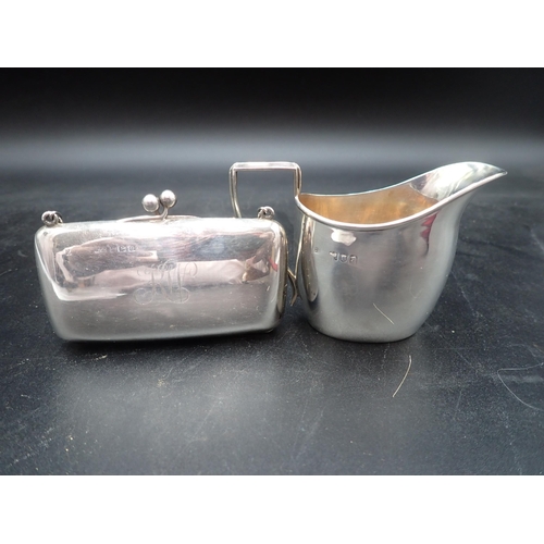 129 - A Victorian silver small oval Jug, London 1896 and a silver purse engraved K.W. with chain, Birmingh... 