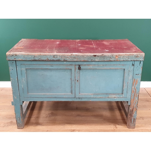 13 - A blue painted Pine Workbench with pair of panelled cupboard doors, 2ft 10