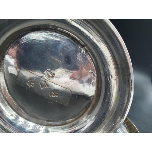 150 - A George II silver Tankard with floral embossing, rococo cartouche engraved coat of arms and motto, ... 