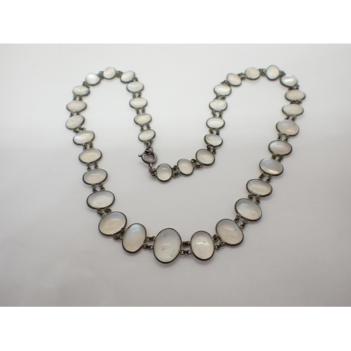 154 - A Moonstone Necklace spectacle-set graduated oval cabochons in white metal