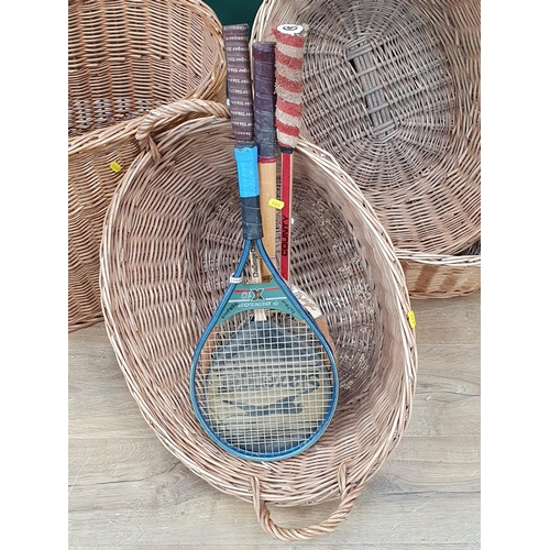 16 - A wicker Laundry Basket and three other wicker Baskets together with two Tennis Rackets and two Badm... 