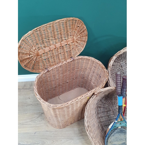 16 - A wicker Laundry Basket and three other wicker Baskets together with two Tennis Rackets and two Badm... 