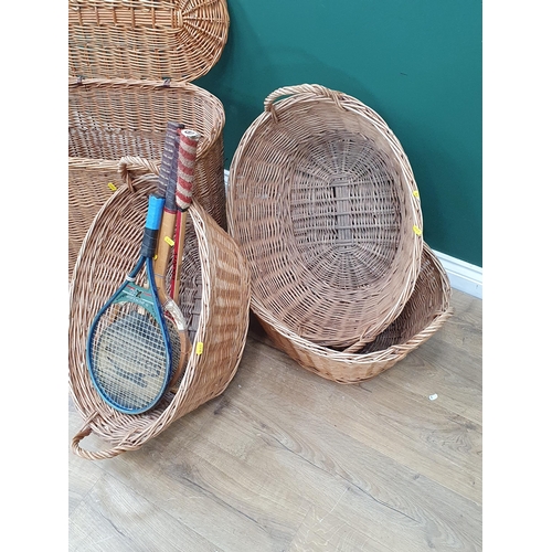 16 - A wicker Laundry Basket and three other wicker Baskets together with two Tennis Rackets and two Badm... 