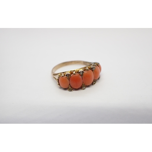 165 - A Coral Ring set graduated oval cabochons with diamond points between in yellow metal, ring size N