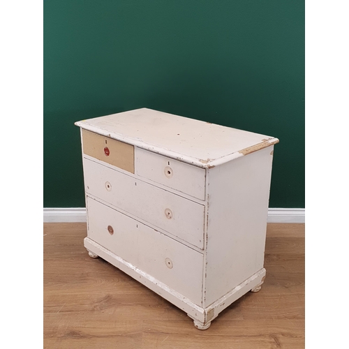 21 - A white painted pine Chest of two short and two long Drawers supported on bun feet A/F, 2ft 7