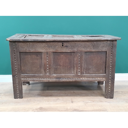 25 - A 17th Century oak Coffer the panelled lid above carved frieze and three panel front A/F.