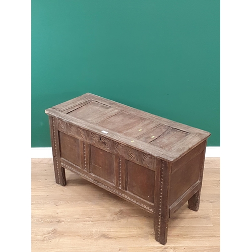 25 - A 17th Century oak Coffer the panelled lid above carved frieze and three panel front A/F.