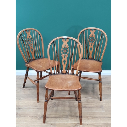 26 - Three Victorian Wheelback Windsor Dining Chairs with solid seats on turned legs united by H stretche... 