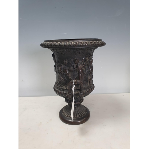 308 - A bronze two-handled Classical Urn with frieze of figures, gadroon base with mask handles, 8½in