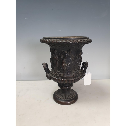 308 - A bronze two-handled Classical Urn with frieze of figures, gadroon base with mask handles, 8½in