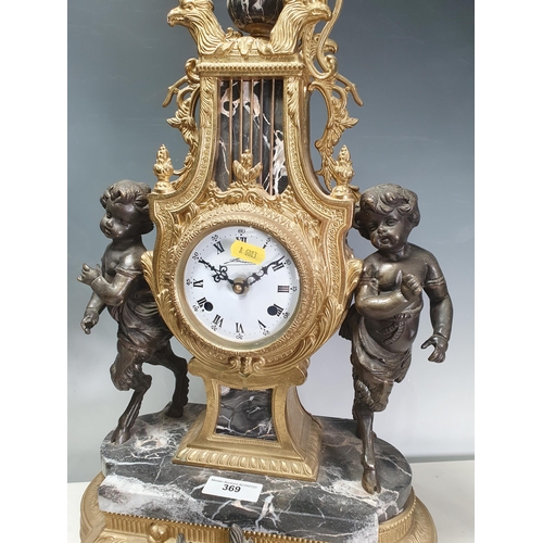 369 - A French style gilt metal Mantel Clock with lyre design, the circular dial flanked by cherub figures... 