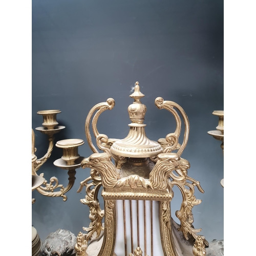 370 - A French style gilt and marble three piece Clock Garniture, the clock with lyre design flanked by ch... 