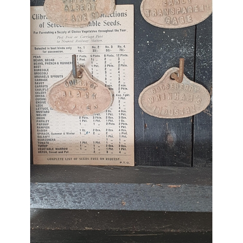 40 - A glazed ebonised Cabinet containing  a quantity of fruit tree labels on hooks, 21 x 15in