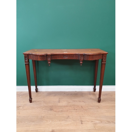 42 - A Mahogany Side Table with carved design on tapering supports.