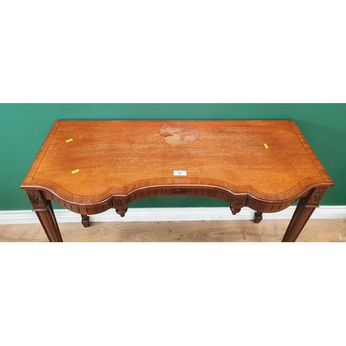 42 - A Mahogany Side Table with carved design on tapering supports.