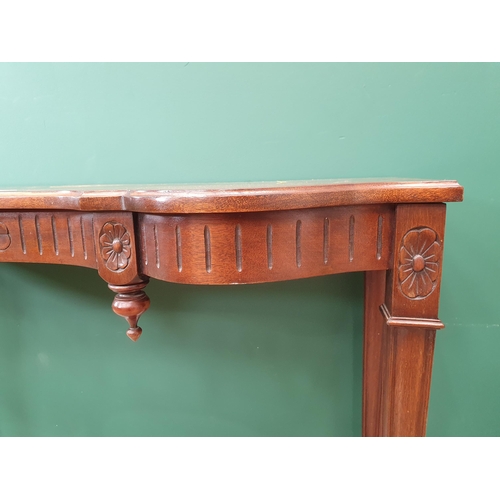 42 - A Mahogany Side Table with carved design on tapering supports.