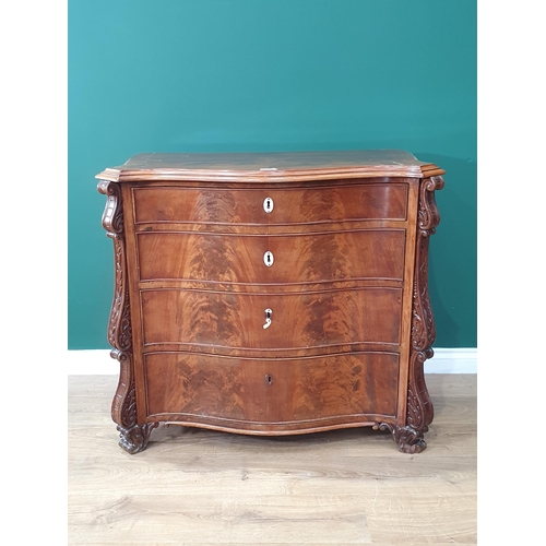 488 - A Walnut chest of four graduated drawers with canted corner applied with carved scrolled decoration