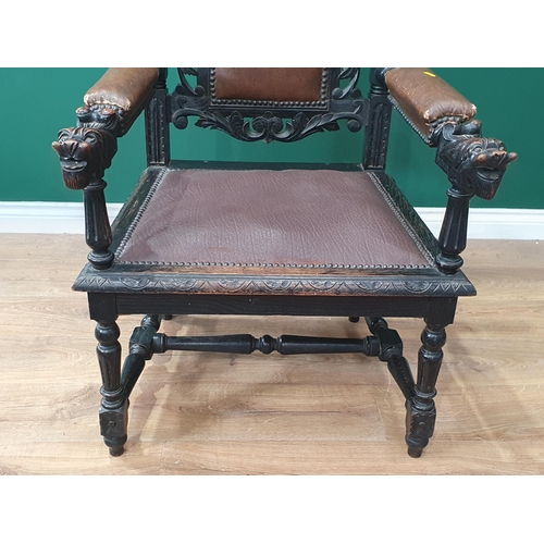 489 - An oak carved Elbow Chair with carved Lion top rail flanked by turned and fluted spindles, with brow... 