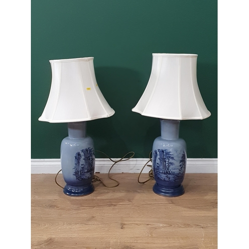 490 - A pair of blue porcelain table lamps with countryside landscape on the sides (Passed PAT Tests)