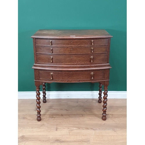563 - An oak bow fronted Canteen Table by Mappin & Webb with four drawers part filled with plated cutlery ... 