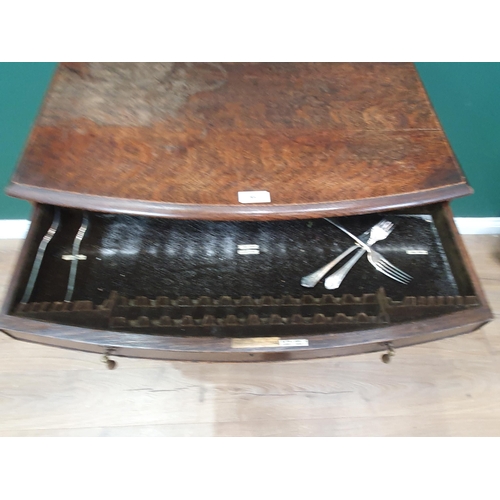 563 - An oak bow fronted Canteen Table by Mappin & Webb with four drawers part filled with plated cutlery ... 