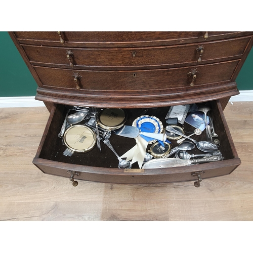 563 - An oak bow fronted Canteen Table by Mappin & Webb with four drawers part filled with plated cutlery ... 