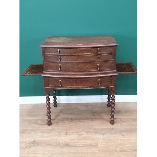 563 - An oak bow fronted Canteen Table by Mappin & Webb with four drawers part filled with plated cutlery ... 