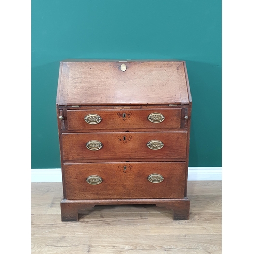 589 - A Georgian oak Bureau of small proportions fitted three graduated drawers and raised on shaped brack... 