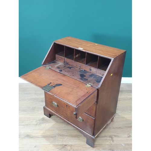 589 - A Georgian oak Bureau of small proportions fitted three graduated drawers and raised on shaped brack... 