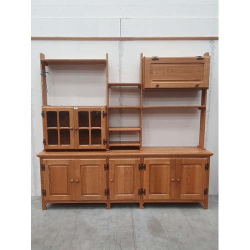 600 - An oak modular Display Unit, the top section with open shelves, a cupboard with pair of glazed doors... 