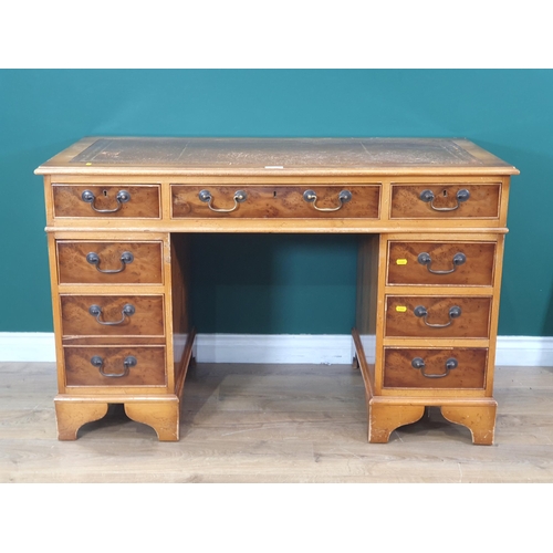 605 - A yew wood veneered Pedestal Desk fitted nine drawers 4ft W x 2ft 6in H