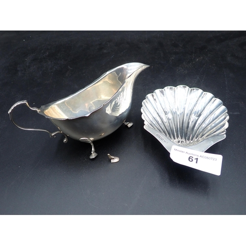 61 - An Edward VII silver Scallop Dish on ball feet, Sheffield 1901, and a Sauce Boat, Birmingham 1963, A... 